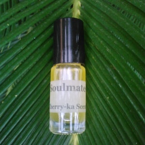 May include: A small glass bottle with a black cap and a white label that reads "Soulmate Cherry-ka Scent".