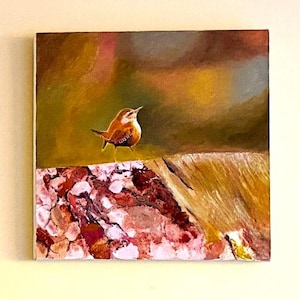 May include: A square painting depicts a small brown bird with a white belly perched on a textured, pink and brown surface. The background is a blend of green, brown, and yellow hues, creating a naturalistic scene. The artwork is mounted on a white canvas.