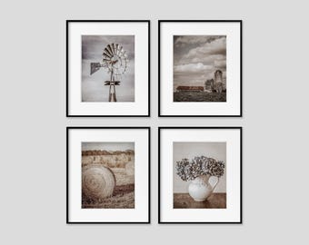 May include: Four framed sepia-toned prints. Top left: a windmill. Top right: a barn and silo. Bottom left: hay bales in a field. Bottom right: a white pitcher with blue flowers.