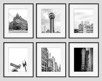 May include: Six framed black and white photographs of architectural landmarks. The images include a building on a street corner, a tall tower with a sphere on top, and a street sign that reads "S Gay".