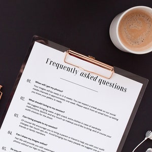 May include: A clipboard with a white sheet of paper with the text "Frequently asked questions" and a list of questions and answers. The clipboard is on a black surface with a cup of coffee and a pen.