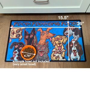 May include: A blue and black dog-themed food mat with the text "FOOD! FOOD! OMG FOOD!" and measurements of 15.5 inches by 26 inches. An orange bowl with dog food is on the mat, measuring 4.75 inches in diameter. The text "example bowl not included (very small bowl)" is below the bowl.