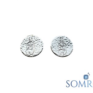 May include: A pair of silver earrings with a textured surface and a stylised human figure design.