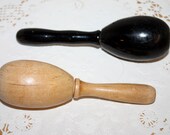 2 vintage wood darners, one is light wood tone and one is black, old sock darners