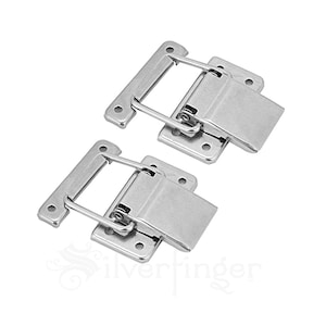 May include: Two silver metal latch clasps with a spring-loaded mechanism. The clasps have a rectangular base with four holes for mounting.