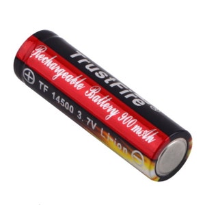 May include: A black and red rechargeable battery labeled "TrustFire Rechargeable Battery 900 mAh TF 14500 3.7V Li-ion".