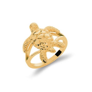 May include: A gold ring featuring a detailed turtle design. The turtle is positioned on top of the ring band, with its head and legs extending out.