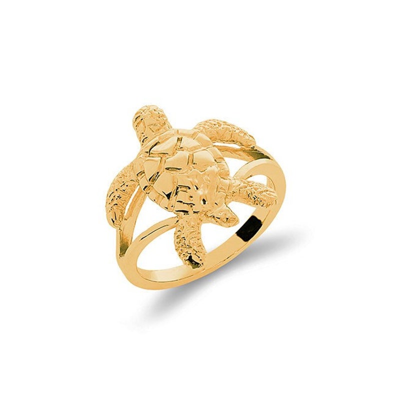 May include: A gold ring featuring a detailed turtle design. The turtle is positioned on top of the ring band, with its head and legs extending out.