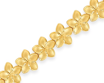 May include: A gold-tone bracelet with a chain made of linked flower-shaped charms.
