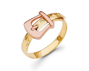 May include: A gold ring with a two-tone buckle design. The buckle is made of rose gold and the band is yellow gold.