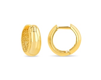 May include: A pair of gold hoop earrings. The earrings are smooth and have a polished finish.