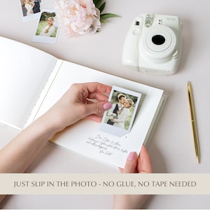 Interior of the personalized wedding guest book showing a Polaroid-style photo page with photo corner slots, no glue or tape required, and handwritten guest message, ideal for instant photo memories.