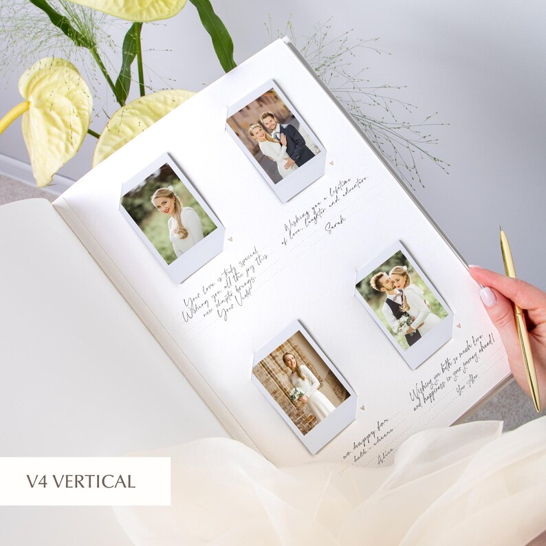 Open wedding guest book resting on the bride’s lap; four vertically oriented Instax/Polaroid prints arranged in a 2×2 layout, secured with white corner mounts; dotted sign‑in lines with heart icons around the photos; gold pen and soft green flowers visible.