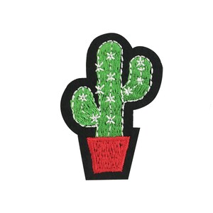 May include: Embroidered green cactus with white flowers in a red pot. The cactus is on a black felt background.