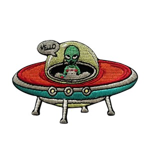 May include: Embroidered patch of a green alien in a flying saucer with the word "Hello" in a speech bubble. The saucer is red, orange, blue, and white.