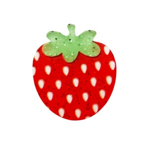 May include: A red and green felt strawberry with white seeds. The strawberry is a craft supply for making decorations.