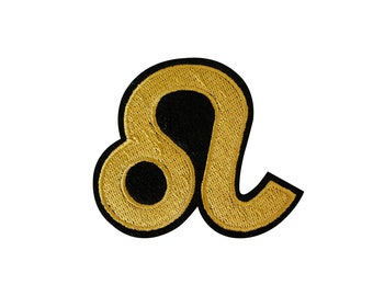May include: Gold embroidered zodiac symbol for Leo, the lion, with a black outline.