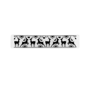 May include: A clear plastic sheet with a repeating pattern of black reindeer silhouettes. The reindeer are in a running pose with antlers and are spaced evenly apart. The sheet is designed for use with a craft project, such as stamping or creating a border.