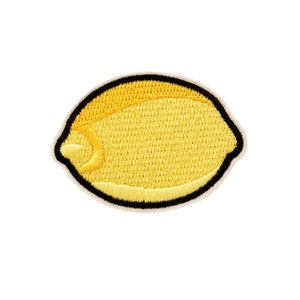 May include: A yellow embroidered lemon patch with a black outline.