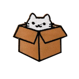 May include: White cat peeking out of a brown cardboard box. The cat has black eyes and a black nose. The box is closed and has a black outline.