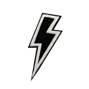 May include: Black and white lightning bolt patch with a white outline.