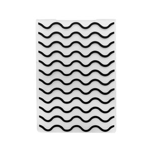 May include: A clear plastic cutting board with a wavy black and white pattern.