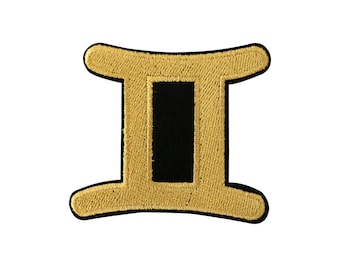 May include: Gold embroidered Gemini zodiac sign patch with a black center.