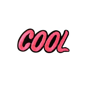May include: Pink embroidered patch with the word "COOL" in black outlined letters.