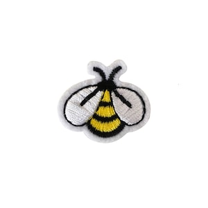 May include: A small embroidered iron-on patch featuring a cartoon bee with yellow and black stripes and white wings.