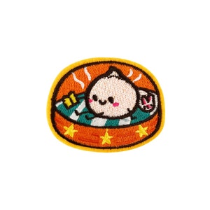 May include: An embroidered patch featuring a cartoon character in a hot tub with steam rising from the water. The character has a round, white body with black eyes and a pink blush. The hot tub is green and white with yellow stars around the edge. The patch is orange with a yellow border.