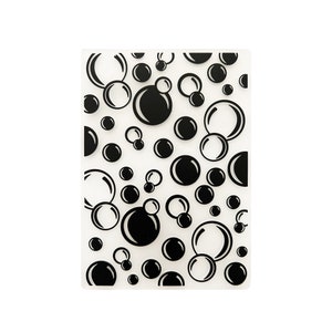 May include: A clear plastic sheet with a repeating pattern of black circles and ovals, resembling bubbles.
