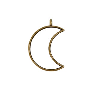 May include: A gold-toned metal crescent moon pendant with a loop at the top for hanging.