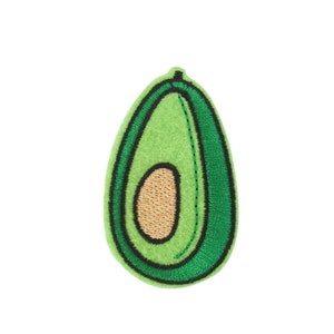 May include: Green felt avocado patch with a brown felt seed inside. The avocado is outlined in black thread.