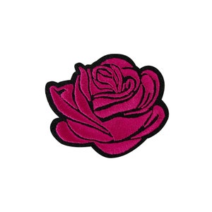 May include: A pink embroidered rose patch with black outline.