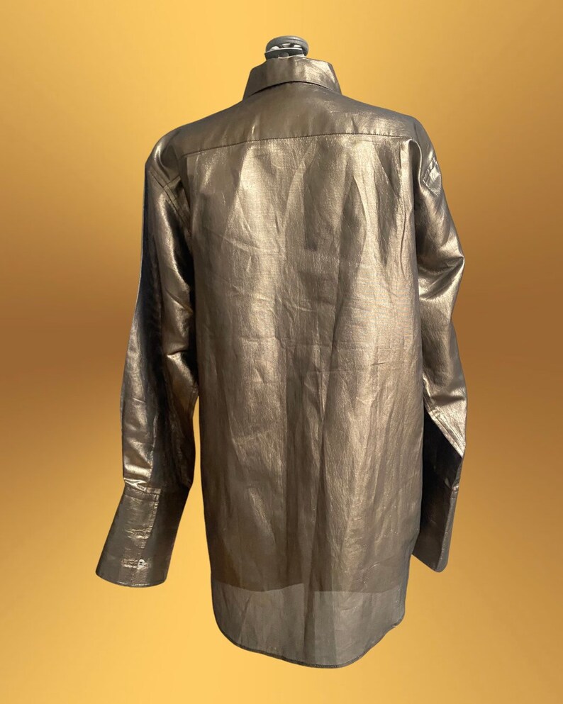 K&ouml;nnte beinhalten: Ein lang&auml;rmliges, metallisch goldenes Hemd mit Knopfleiste und leicht lockerer Passform.