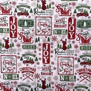 May include: A white fabric with a repeating pattern of red and green Christmas-themed illustrations. The illustrations include reindeer, sleighs, Christmas trees, candy canes, and signs with phrases like "Merry & Bright", "Joy", "Peace on Earth", and "Good Tidings of Comfort & Joy".