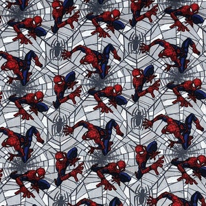 May include: A white fabric with a repeating pattern of red and blue Spiderman characters crawling on a gray spider web.