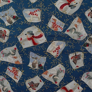 May include: A fabric with a repeating pattern of winter scenes on a dark blue background. Each scene features a snowman, polar bear, fox, or other animal wearing a scarf. The scenes are framed by gold-colored leaf designs.