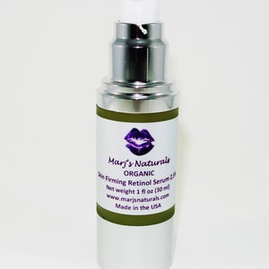 May include: A silver and white pump bottle of Marj's Naturals Organic Skin Firming Retinol Serum 2.5%. The label features a purple lip design and product information. Net weight is 1 fl oz (30 ml). Made in the USA.