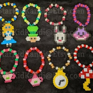 May include: Ten colorful beaded bracelets with different charms. The charms are pixelated and include Alice in Wonderland characters like the Mad Hatter, the White Rabbit, and the Queen of Hearts.
