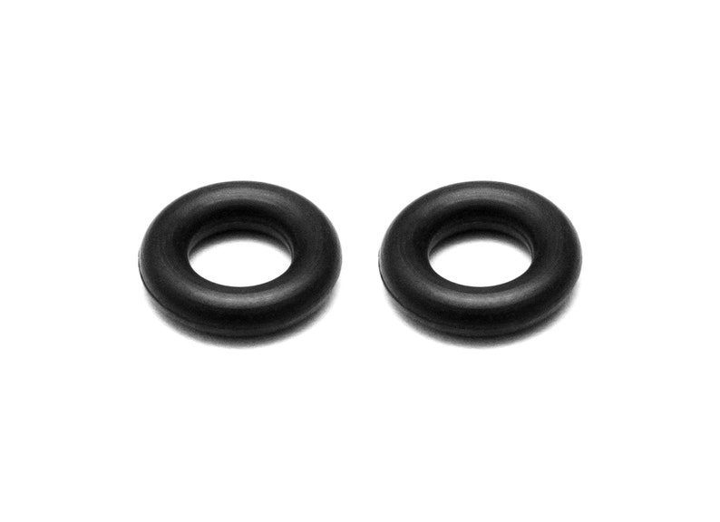 May include: Two black rubber o-rings. These o-rings are commonly used in plumbing and other applications to create a seal.
