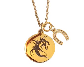 May include: Gold-coloured necklace with a round pendant featuring a black horse head design and a horseshoe charm embellished with small, clear crystals. The chain and charms have a polished finish.