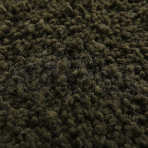 May include: Close-up of a dark green fuzzy fabric texture. The fabric has a soft, plush feel and is perfect for creating cozy and comfortable items.