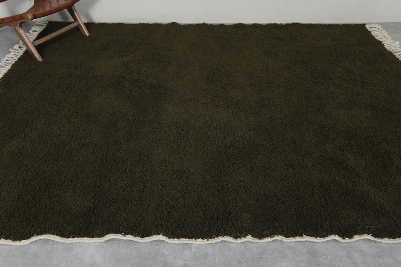May include: A dark green shag rug with a white fringe border.