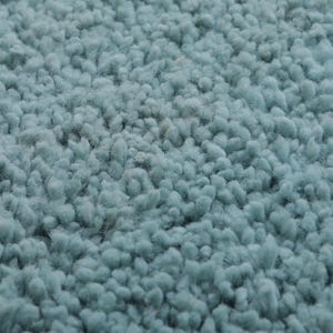 May include: Close-up of a light blue shag rug with a soft, fuzzy texture.