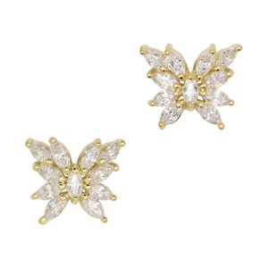 May include: A pair of gold butterfly earrings with clear marquise-shaped stones.