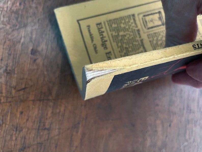 May include: A vintage book with a yellow cover and black text. The title of the book is "Eldridge Enterprises" and the text on the cover says "Franklin, Ohio".