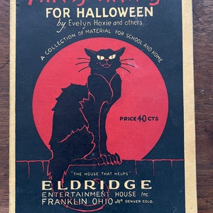 May include: A vintage book cover with a black cat silhouette against a red moon. The title is "Hints and Ha'nts for Halloween" by Evelyn Hoxie and others. The book is a collection of material for school and home. The price is 40 cents. The publisher is Eldridge Entertainment House Inc. in Franklin, Ohio, also Denver, Colorado.