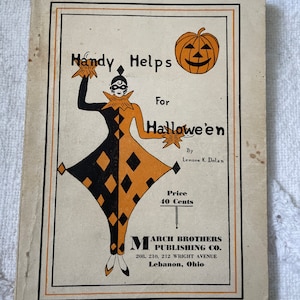 May include: A vintage book cover with a black and orange illustration of a jester holding a star. The title is "Handy Helps for Hallowe'en" by Lenore K. Dolan. The book is published by March Brothers Publishing Co. in Lebanon, Ohio.