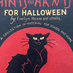May include: A vintage book cover with a black cat silhouette against a red background. The title is "Hints and Hants for Halloween" by Evelyn Hoxie and others. The book is a collection of material for school and home. The price is 40 cents.